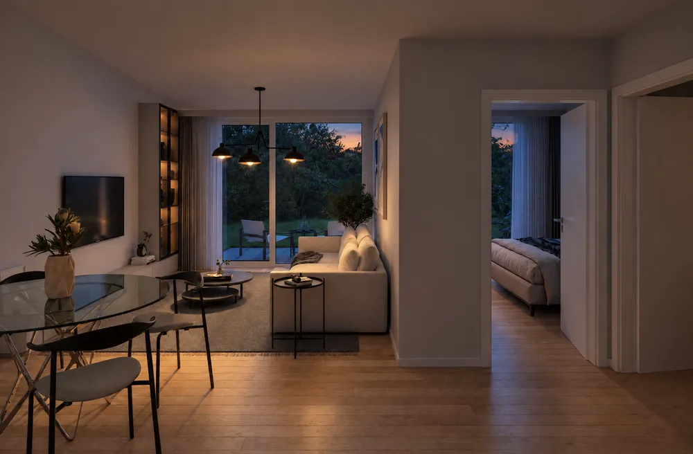 Séjour éclairé le soir, vue sur le jardin